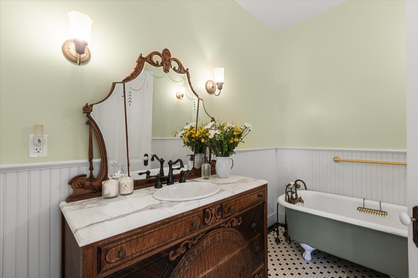 Period bathroom with antique vanity and clawfoot tub